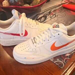 White Nike Air Force 1 Sneakers with Red and Orange Swoosh
